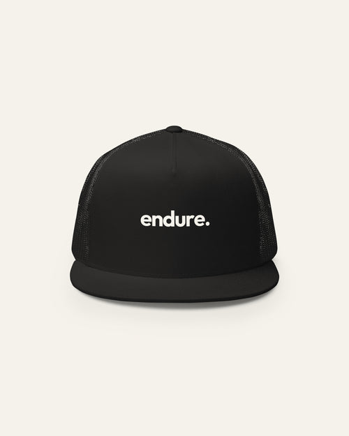 Black melowear endure. trucker cap from the front, wordmark printed on the panel
