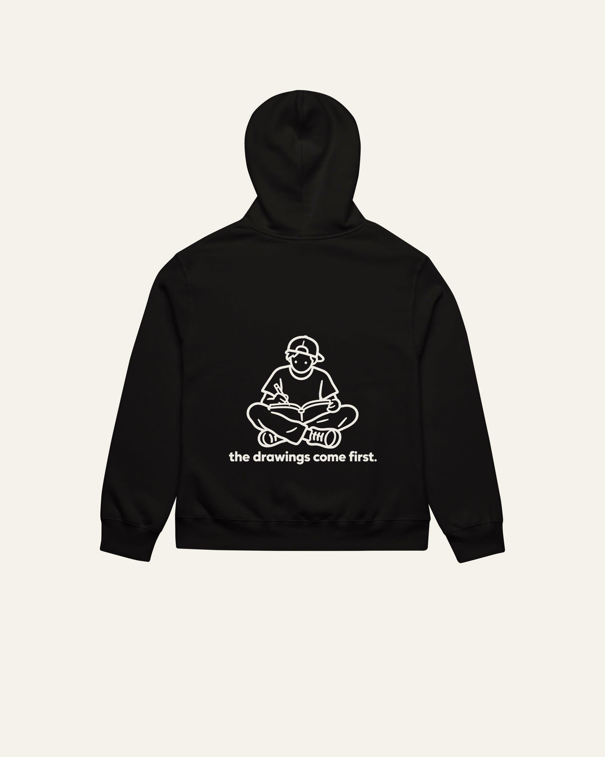 melowear the drawings come first hoodie, back print: a kid on the floor with a sketchbook, drawing